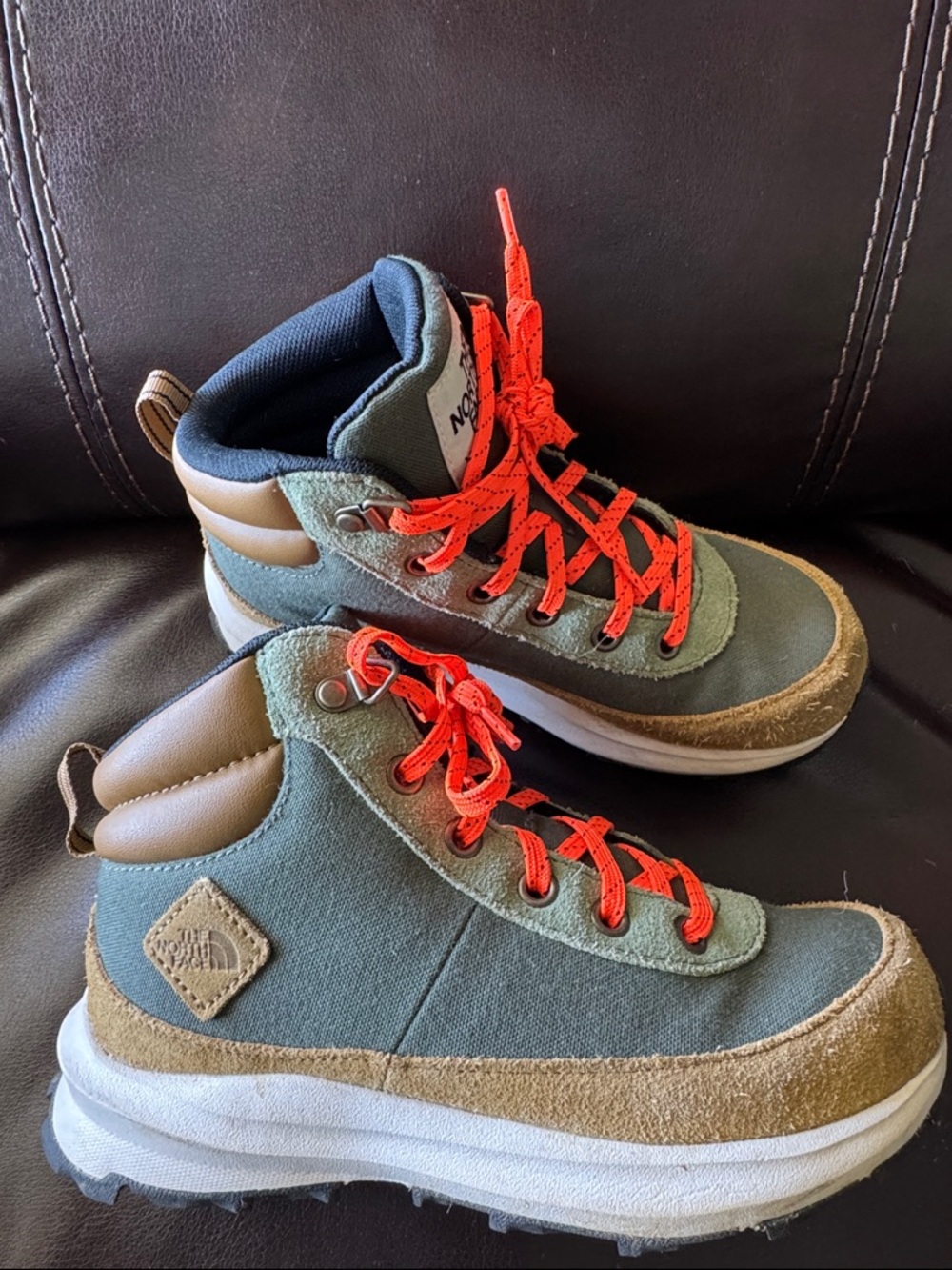 The North Face Green Hiking Boots with orange laces.  Size 3. Great condition.
